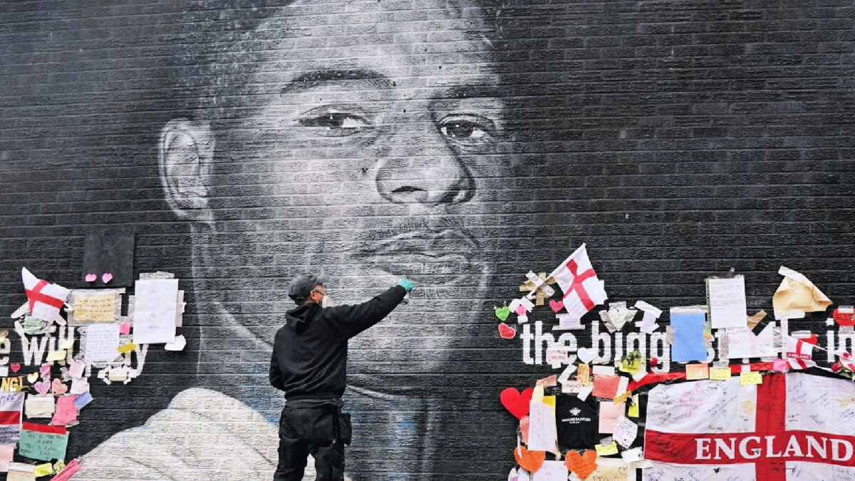 Akse repairing Marcus Rashford's mural in Withington