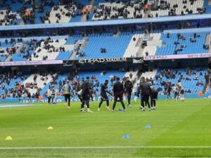 Man City players warming up at the Etihad Stadium